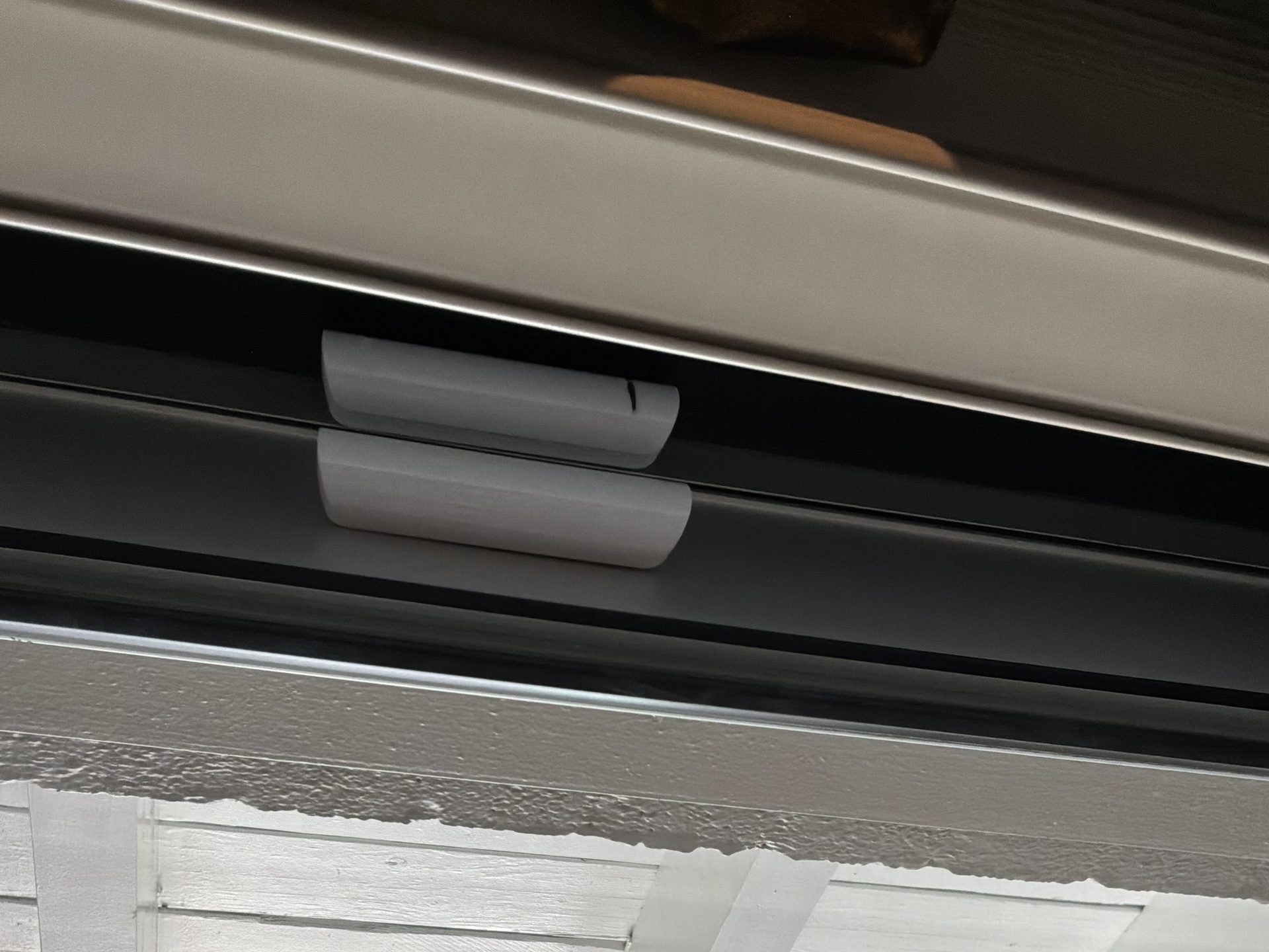 An Ajax DoorProtect contact on a patio door of a Tacoma waterfront home