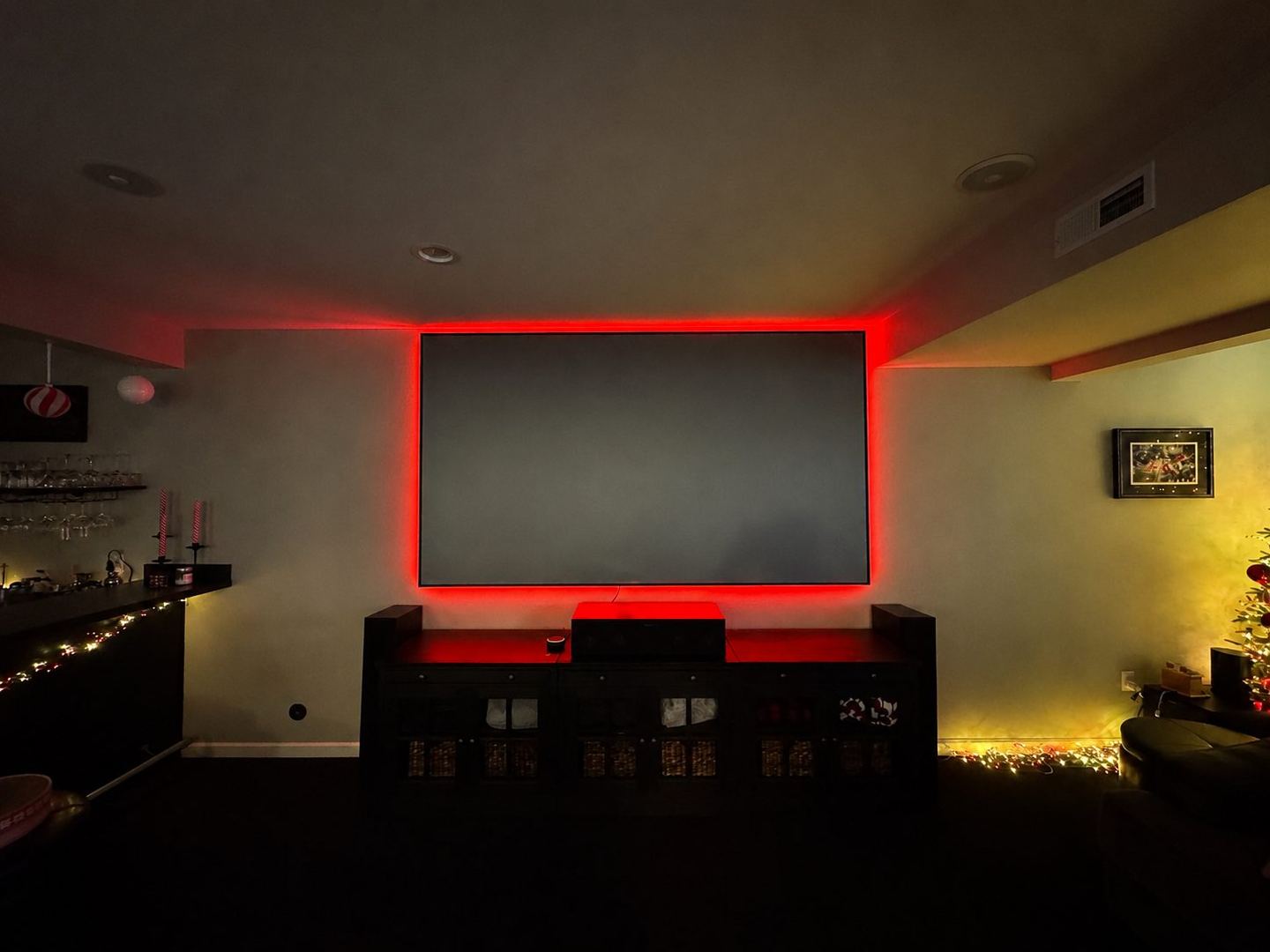 Home theater with red bias lighting and a 120-inch screen