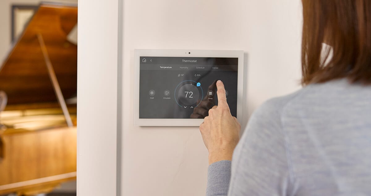Homeowner adjusting smart thermostat