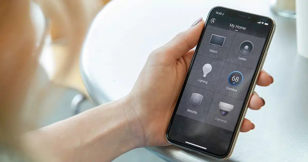 Person holding phone showing home automation options